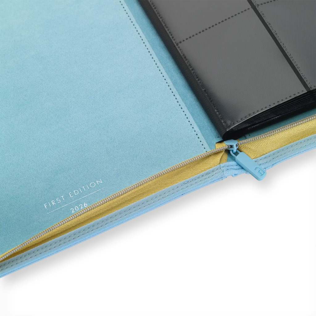 Close-up of a soft covered planner with a blue and yellow zipper, featuring a black binder inside labeled 'First Edition 2026'.