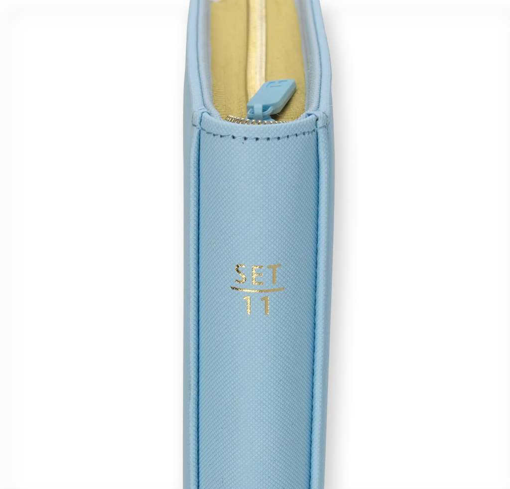 Close-up of a light blue zipper pouch with a gold 'SET 11' inscription on the side.
